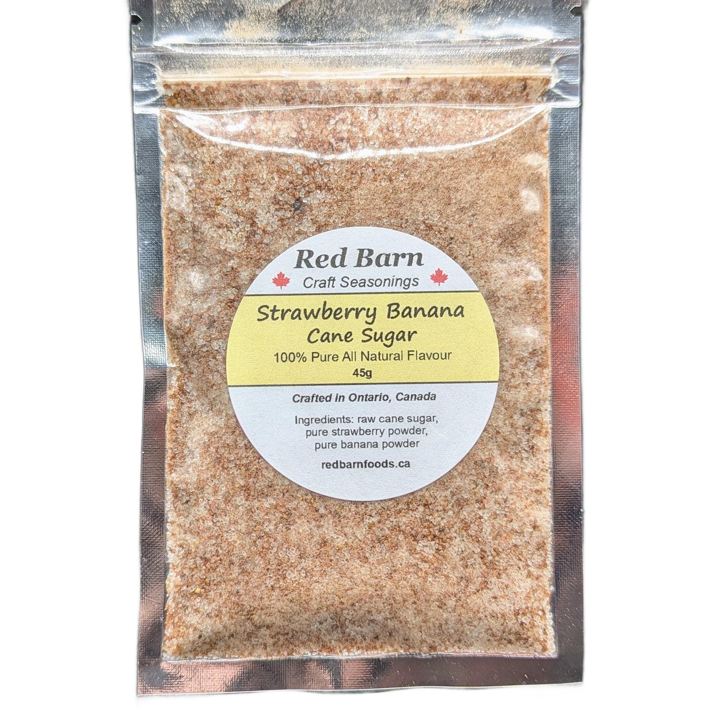 Packaged strawberry banana cane sugar with Red Barn label on a white background