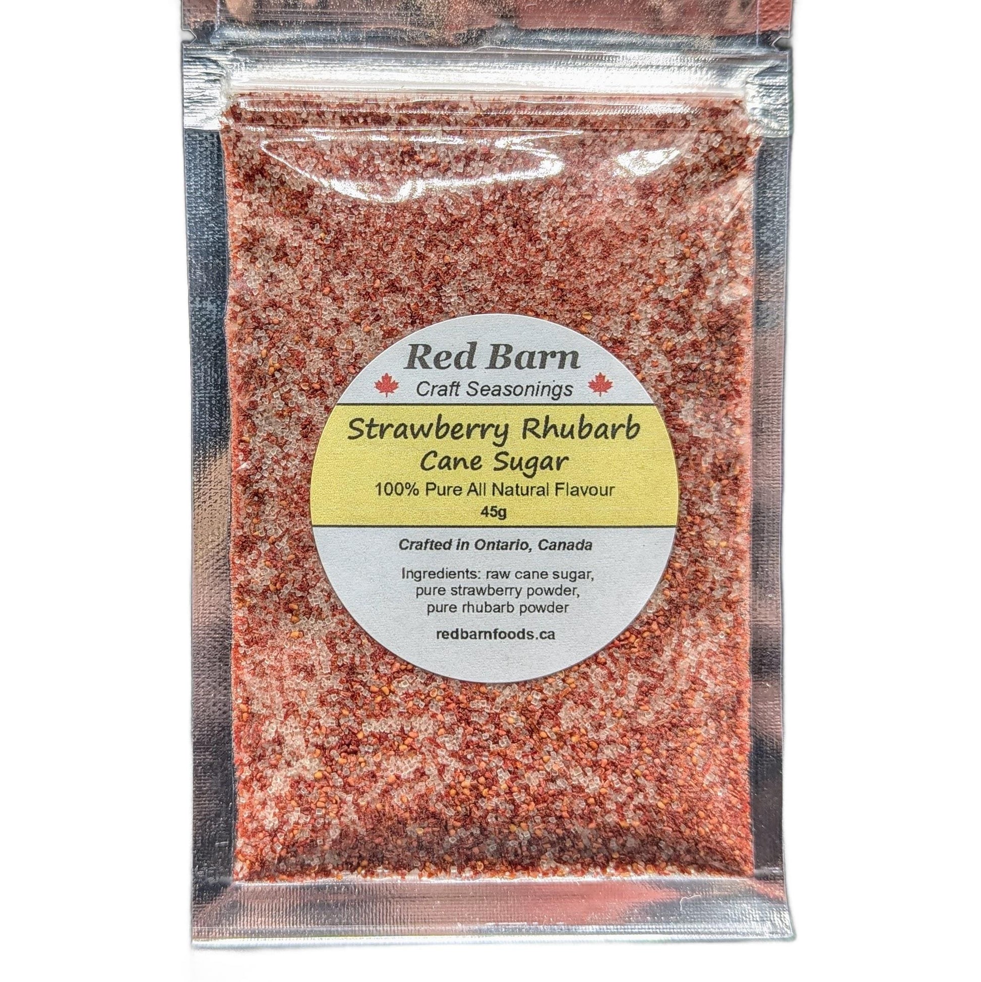 Packaged strawberry rhubarb cane sugar with Red Barn label on a white background